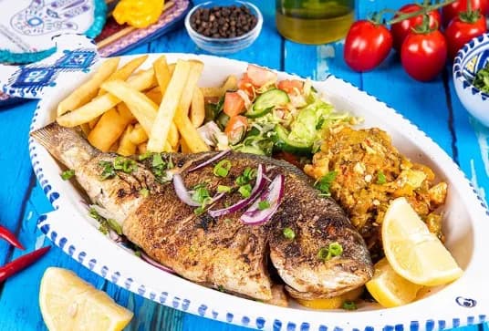 Daily catch grilled fish served with lemon
